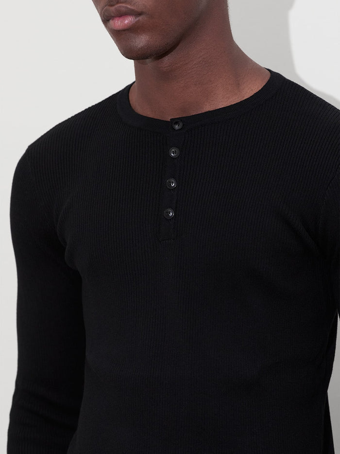 detail of male model wearing black rib knit henley one dna