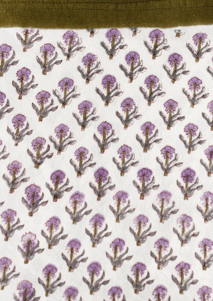 A purple and olive green floral print tablecloth.