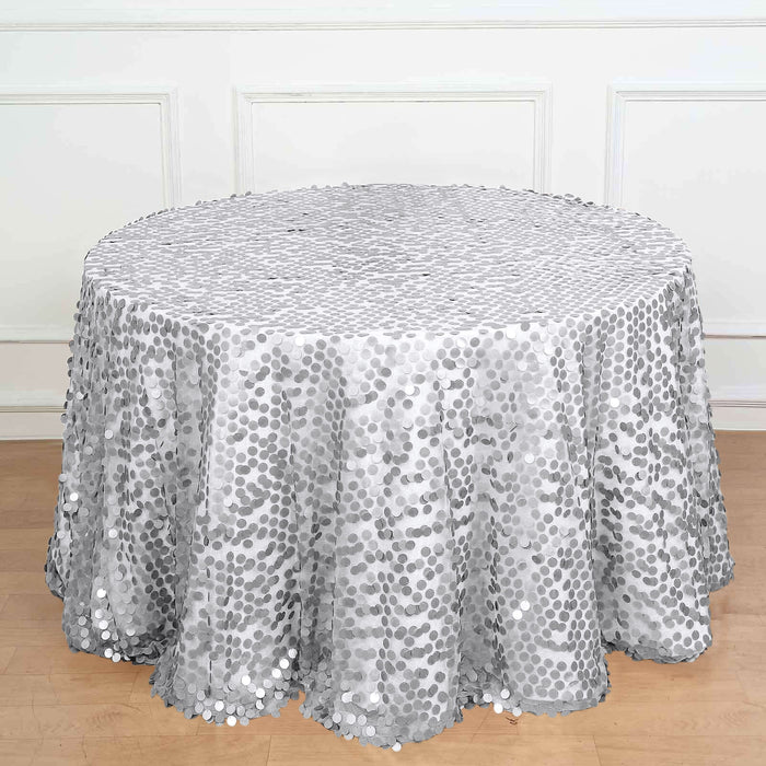 Silver sequin tablecloth on a round table, showcasing a shimmering design.