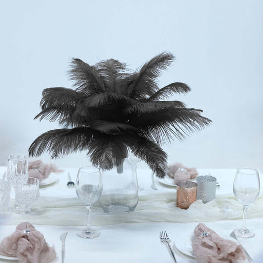Elegant black feather centerpiece on a dining table setting.