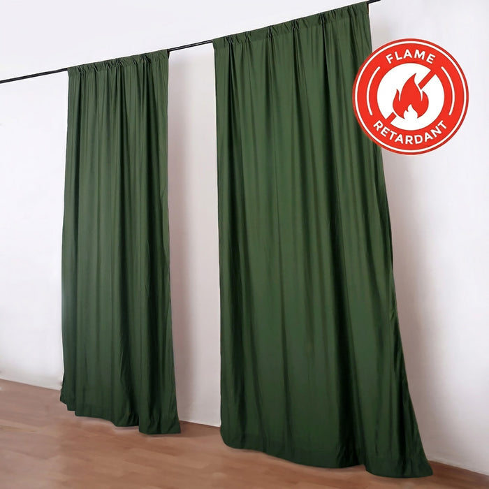 Green flame retardant curtains hanging on a black rod in a room