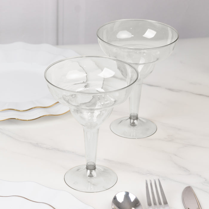 Two elegant glass margarita glasses on a marble table.