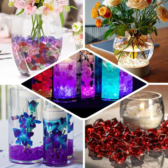 Colorful decorative glass gems in various arrangements with flowers and candles.
