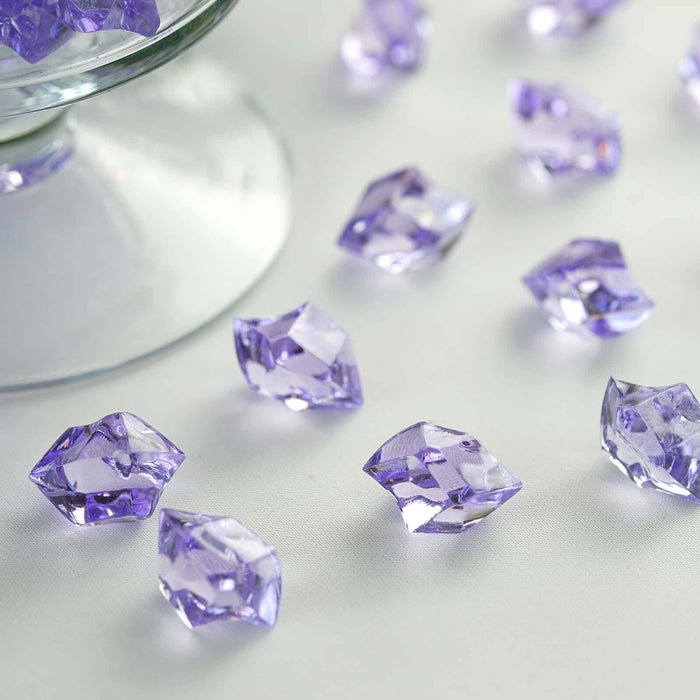 Purple crystal decorative gems scattered on a white surface.