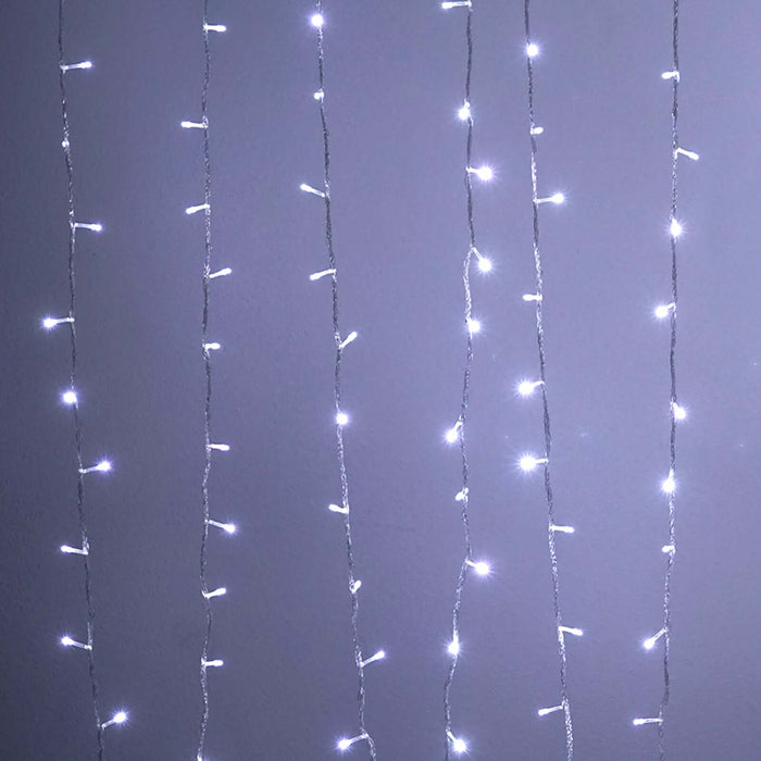 String of white fairy lights against a plain background.