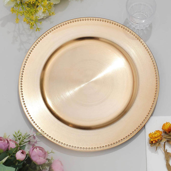 Gold charger plate with beaded rim, perfect for elegant table settings.