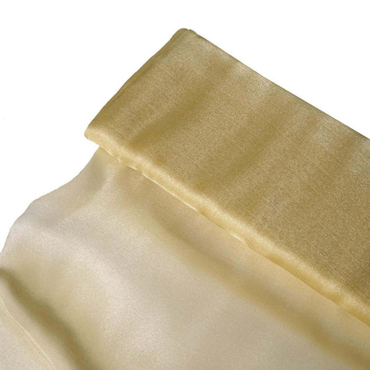 Gold satin fabric draped elegantly on a white background. #whtbkgd