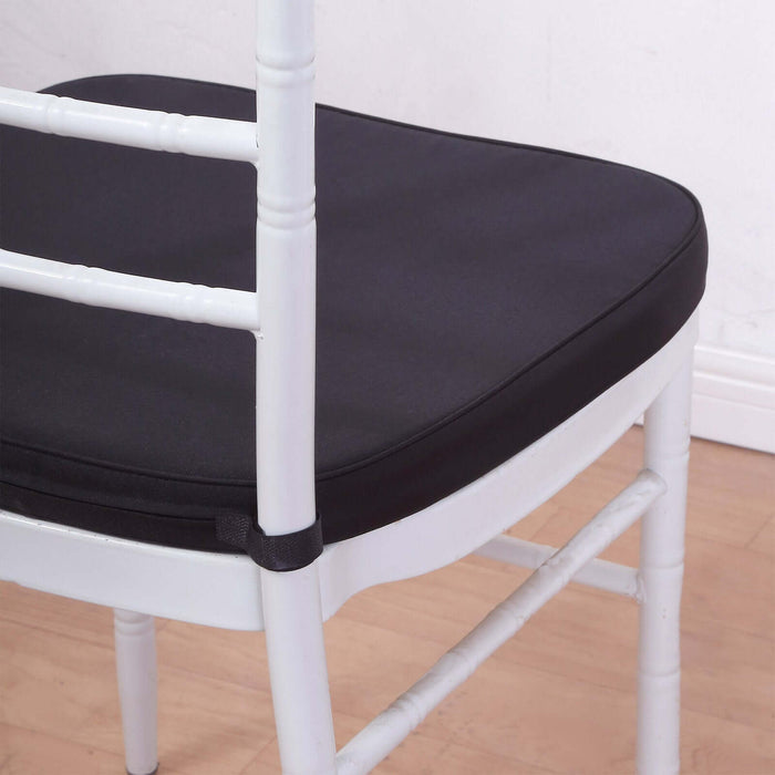 Black chair cushion on a white chair, highlighting comfort and style.