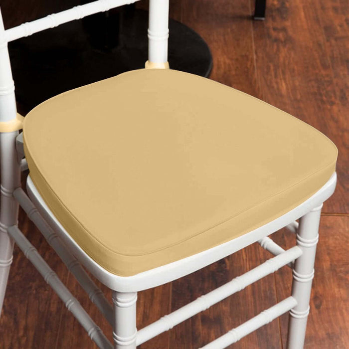 Beige chair cushion on a white chair against a wooden floor.