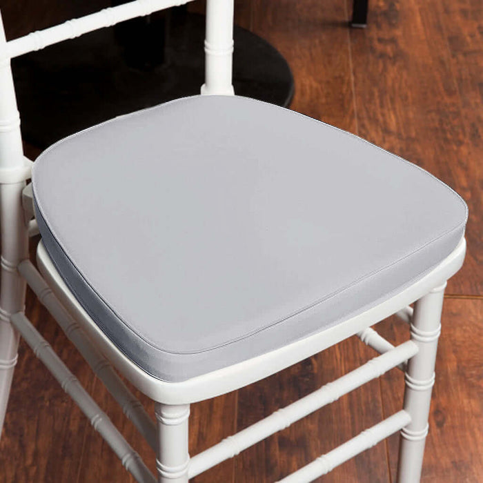 Gray chair cushion on a white chair against a wooden floor