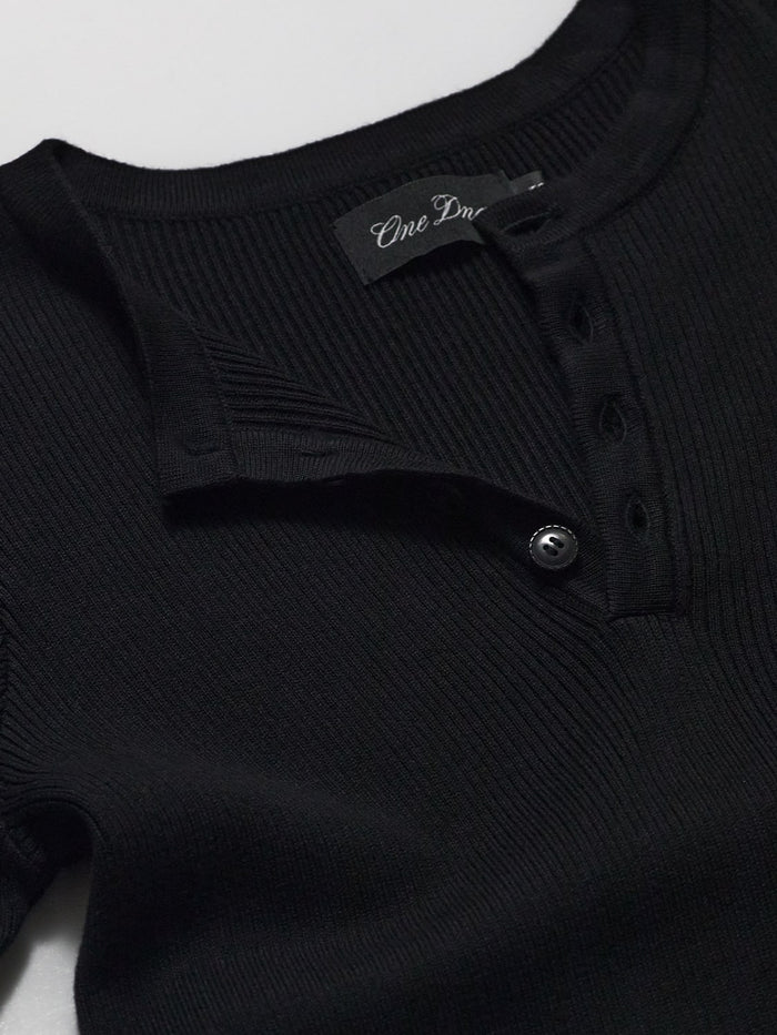 Detail of black ribbed knit henley by One Dna brand