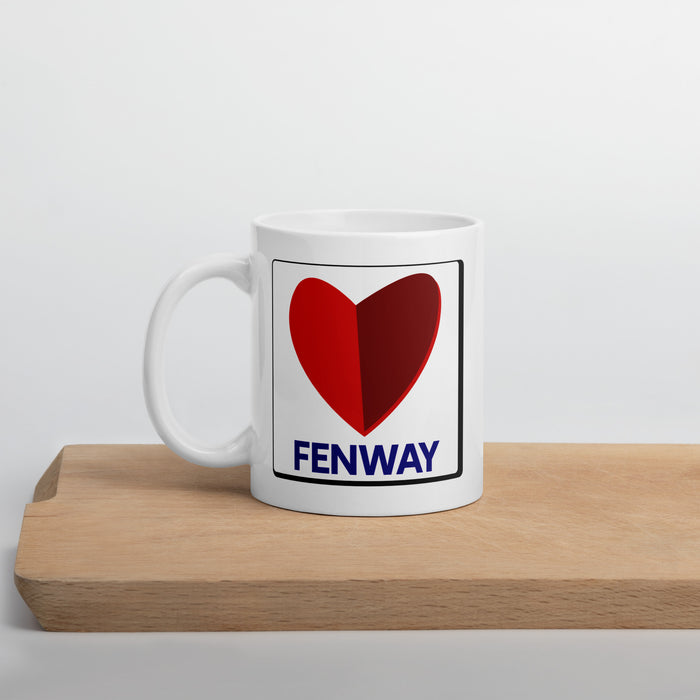 white ceramic mug with the boston fenway citgo sign in the shape of a heart on a cutting board