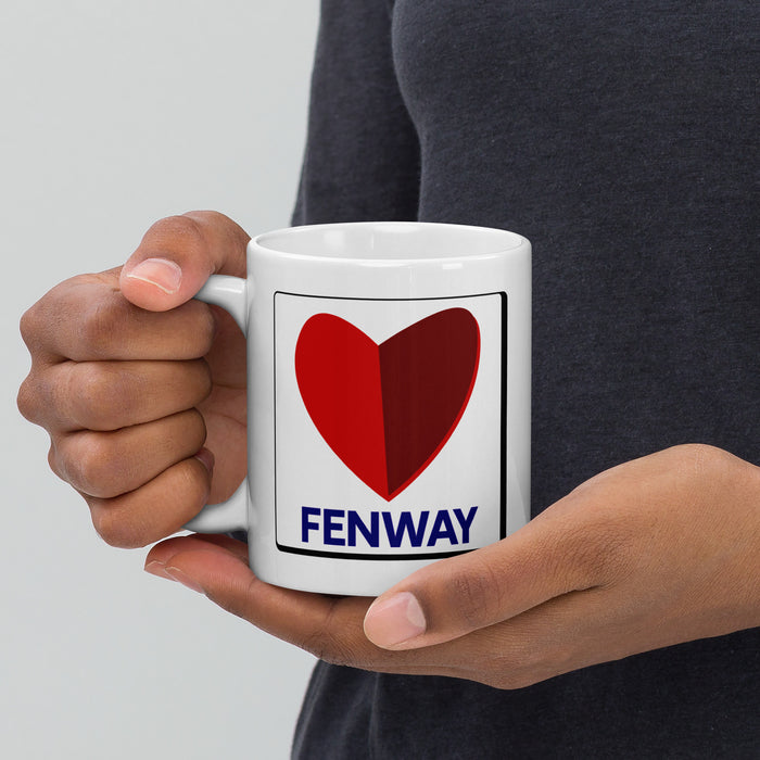 person holding white ceramic mug with the boston fenway citgo sign in the shape of a heart