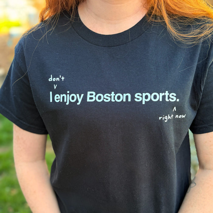 woman wearing I don't enjoy Boston sports right now. t-shirt, black unisex tee with handwritten annotation over original design