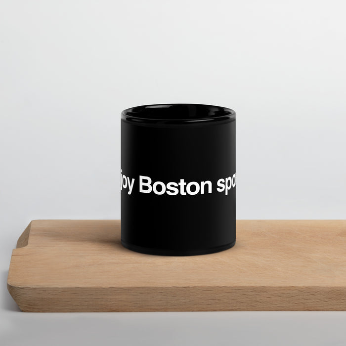 Photo of black glossy mug with the phrase i enjoy boston sports in white lettering
