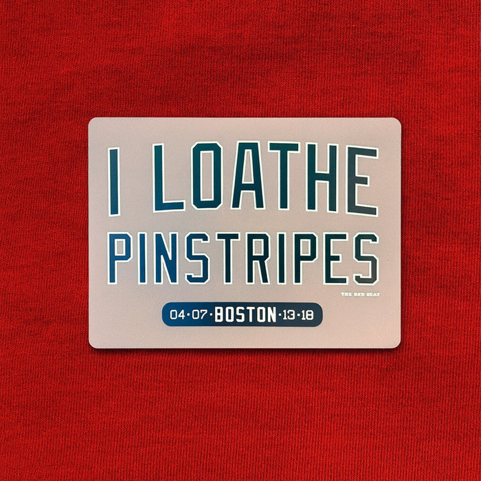 Refrigerator magnet with text 'I LOATHE PINSTRIPES' on a red background