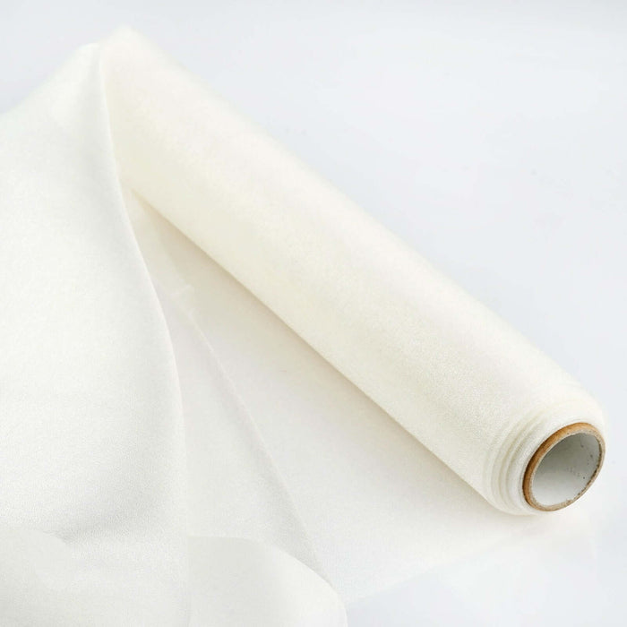 Roll of sheer white fabric on a plain white background