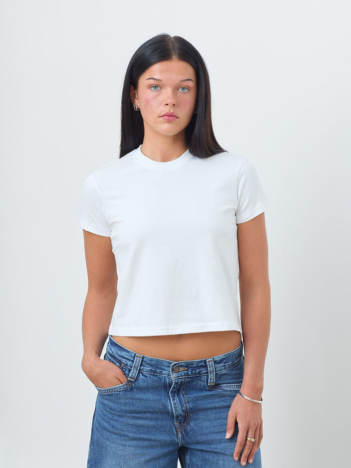 The Jane white t-shirt by ONE DNA modeled by a female model on a flat gray background