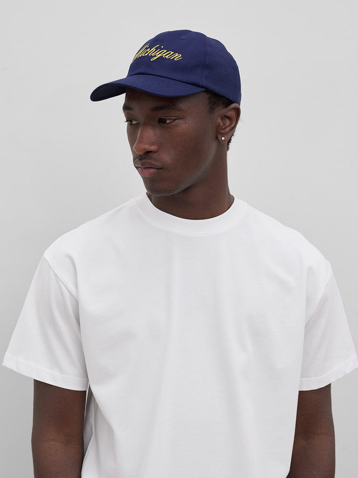 model wears michigan script navy hat by one dna