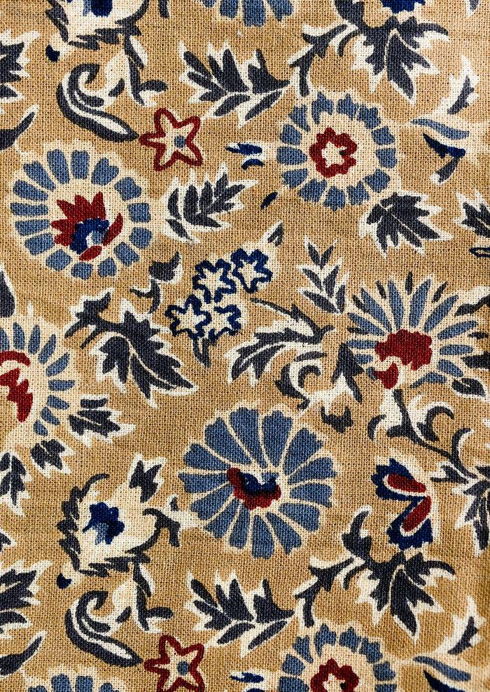 A floral print napkin set in brown, indigo and red.