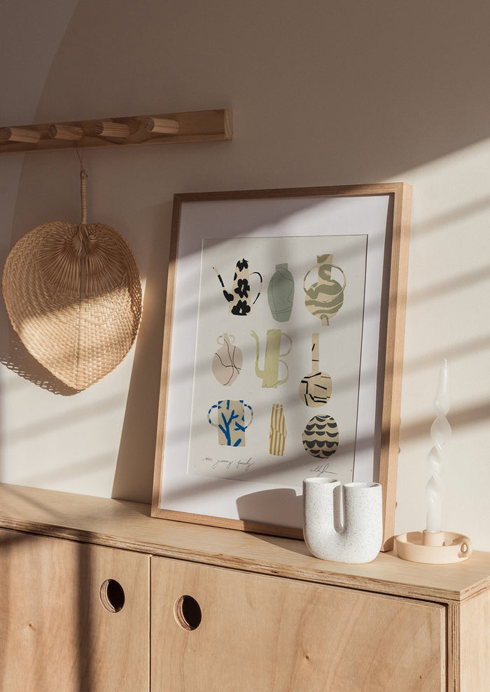 An art print with drawings of different vessels, framed.