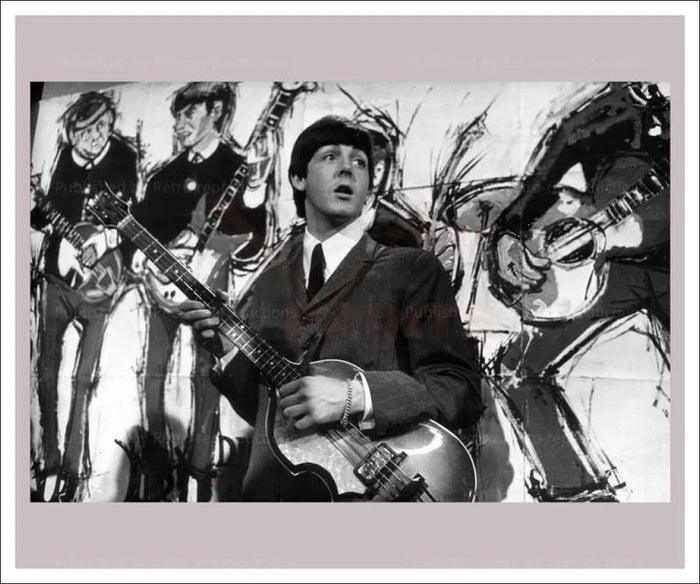 Paul McCartney in front of Beatles Painting - VINTAGEARTREPRINTS.COM