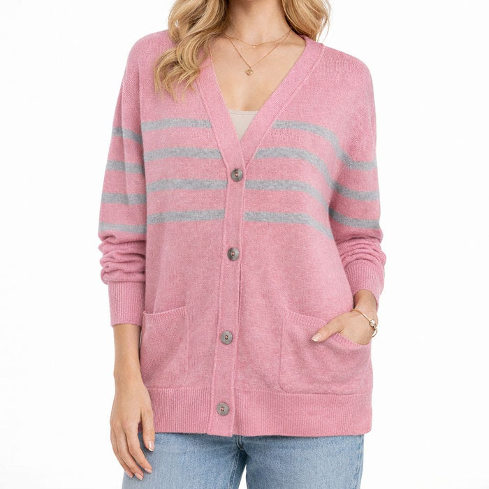 Woman wearing a pink cardigan with gray stripes on a white background
