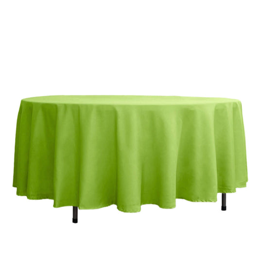 Green round tablecloth on a white backdrop.