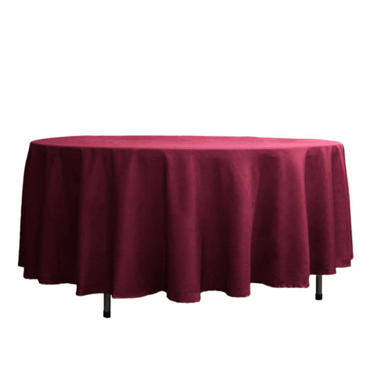 Burgundy tablecloth draped over a round table