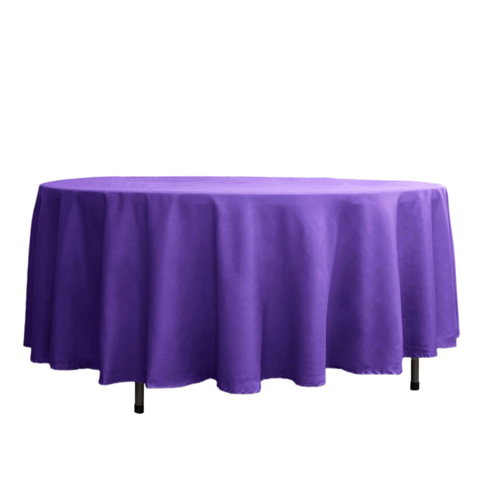Purple round tablecloth on a table against a white background.
