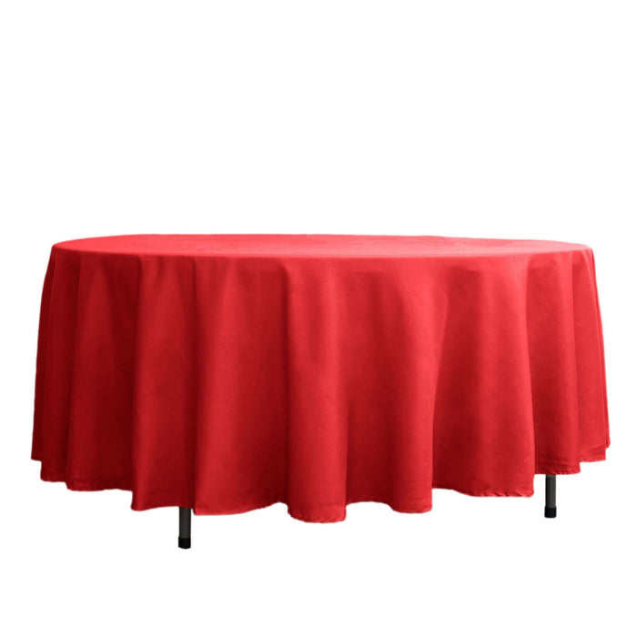 Red tablecloth draped over a round table on a plain white background