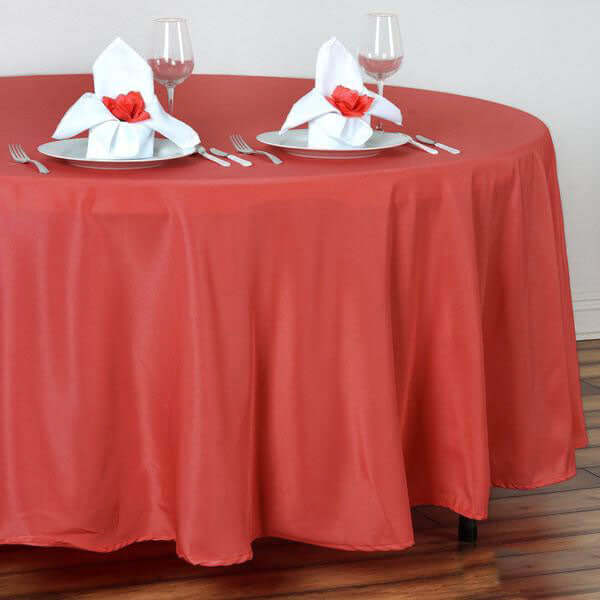 Red tablecloth with elegant napkin settings for dining table.