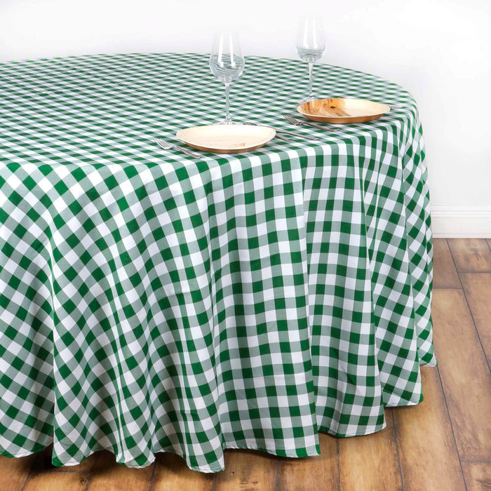 Green and white checkered tablecloth on a wooden table with plates and glasses.