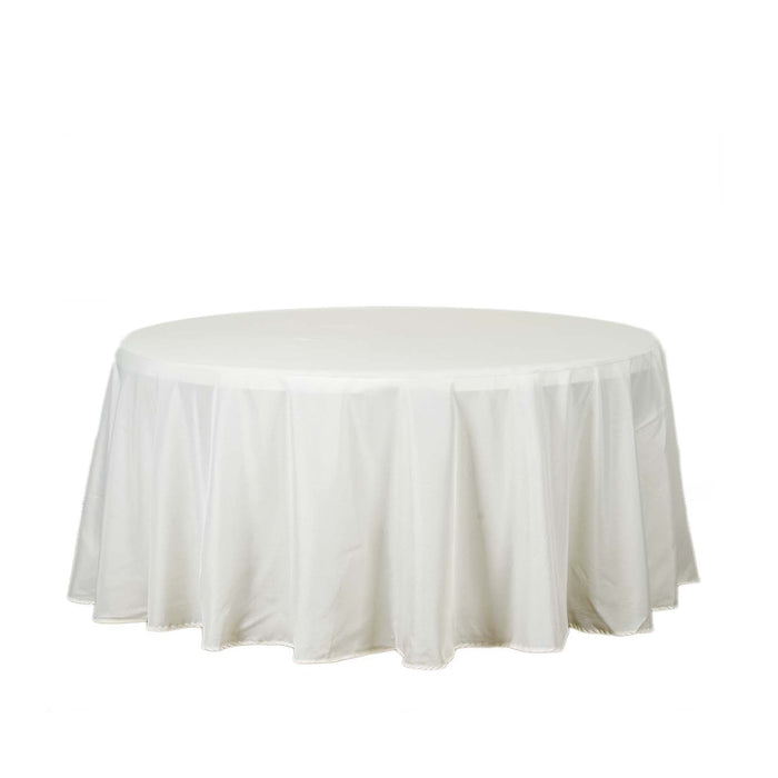 Round white table with elegant draped tablecloth