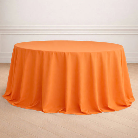 Round orange tablecloth draped elegantly on a table.