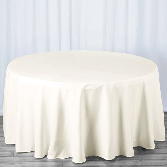 Round ivory tablecloth draped over a circular table.