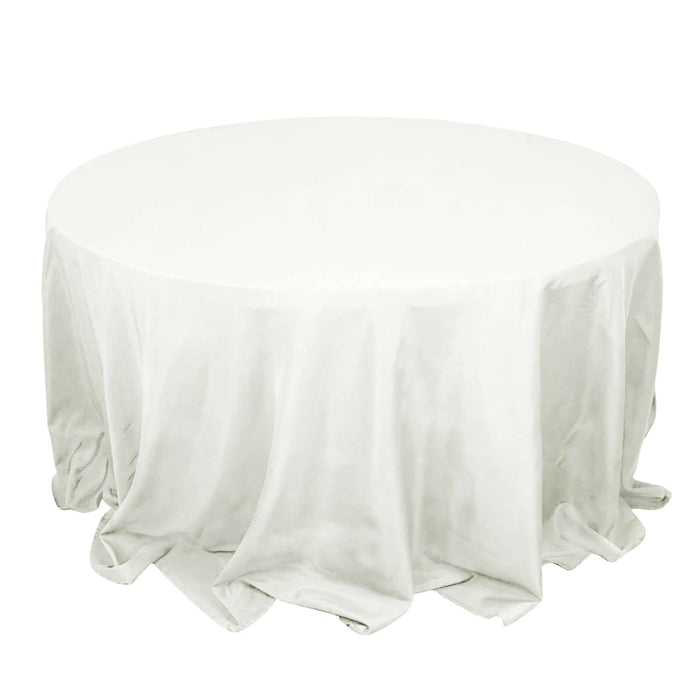 Round table with a white tablecloth elegantly draped.