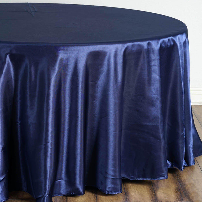 Navy blue satin tablecloth draping over a round table