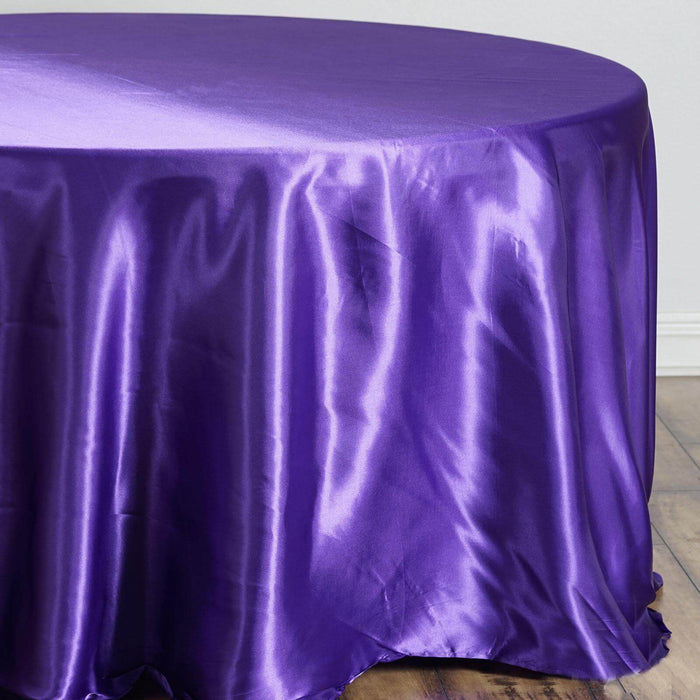 Purple satin tablecloth draped over a round table.