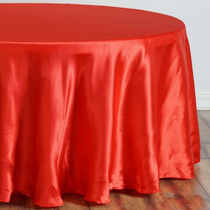 Red satin tablecloth draping elegantly over a round table.