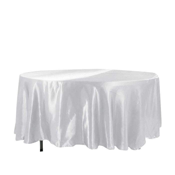 White satin round tablecloth draped elegantly over a table
