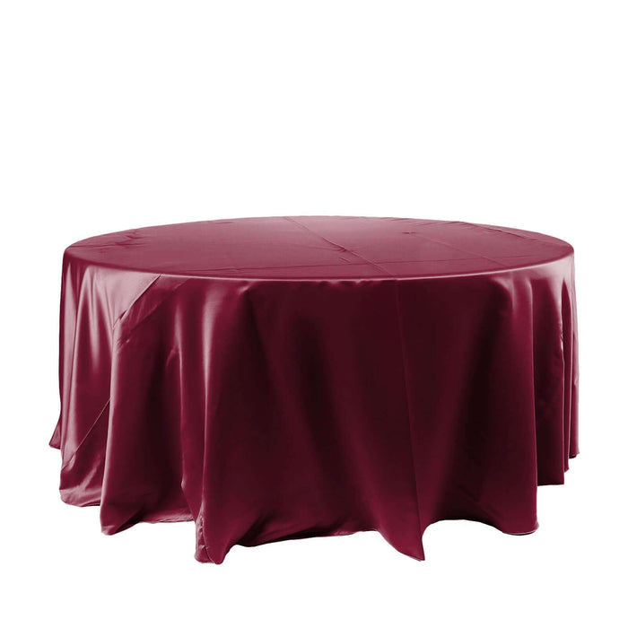Burgundy round tablecloth draped over a circular table