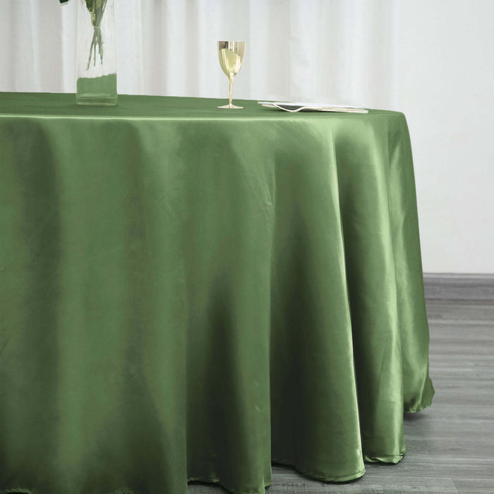 Elegant green tablecloth draped on a table with a glass and vase.