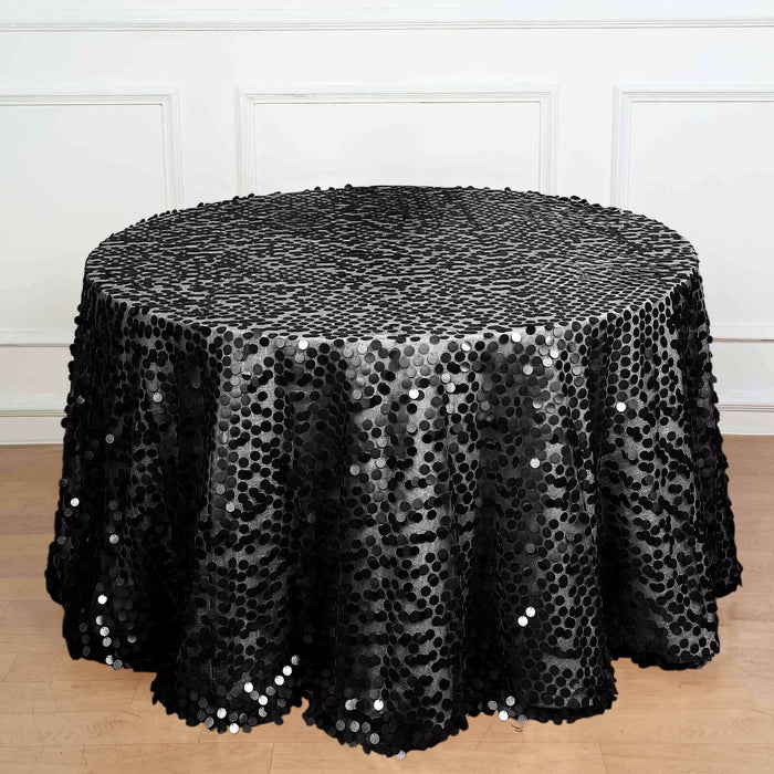 Black sequin tablecloth draped over a round table.