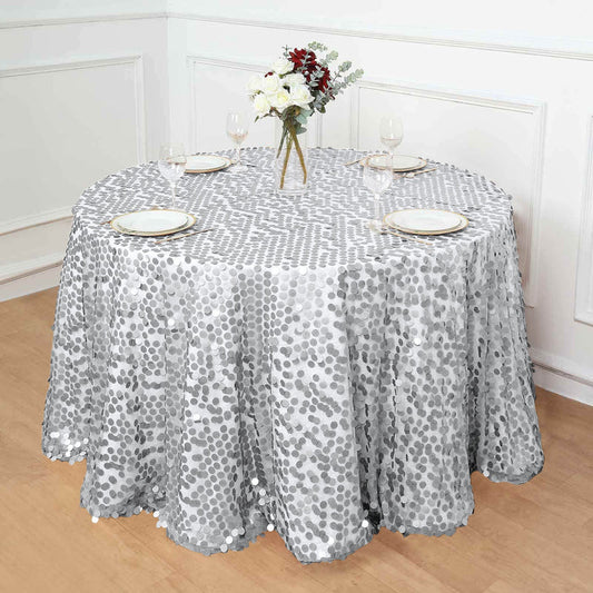 Silver sequined tablecloth draping a round table with floral centerpiece.