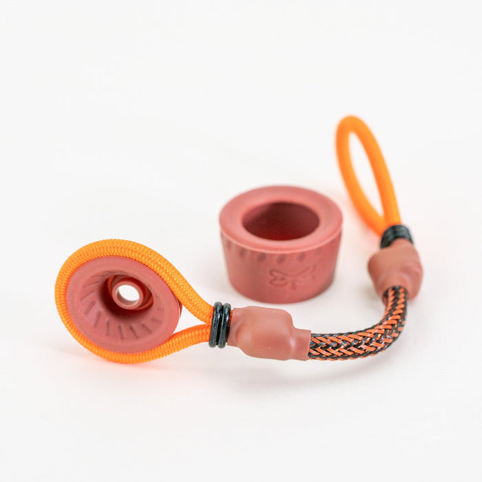 Brown and orange tether attachment laying on white background