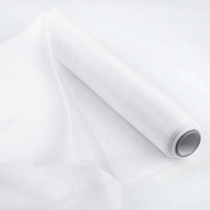 Roll of sheer white fabric on a white background.