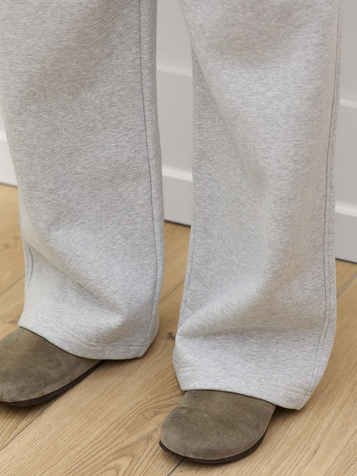 close up of model wearing heather gray sweatpants one dna